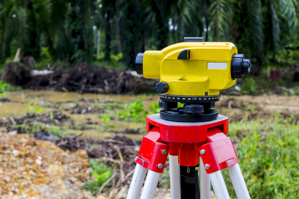 Surveyor,equipment,tacheometer,or,theodolite,on,new,palm,oil,plantation.